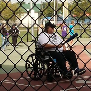 Friends Club Member playing Baseball in the Miracle League using a wheelchair